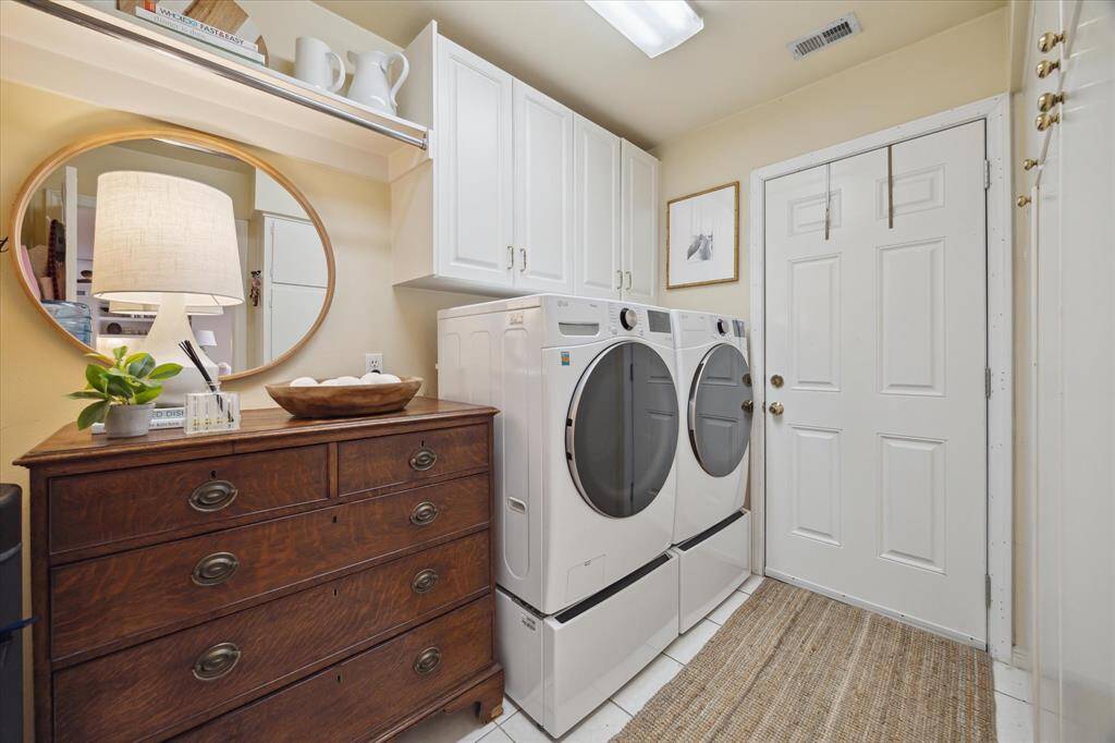 The laundry room is located off the kitchen and includes new LG energy-efficient front load washer and dryer that were purchased in 2024. The laundry room also includes ample built-in storage (on right) and a door leading to the backyard.
