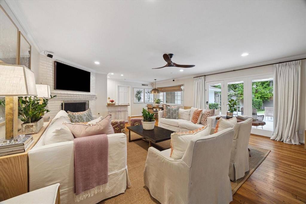 This family room is the heart of the home and features a large gas fireplace and built in dry bar (not shown - on opposite wall). This room is ample in size and perfect for hosting large gatherings! The windows and door provide fabulous views of the retreat-like backyard.