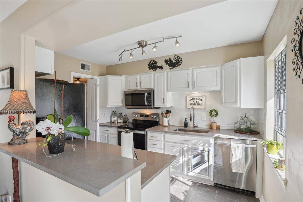 Kitchen featuring quartz countertops and stainless steel appliances.