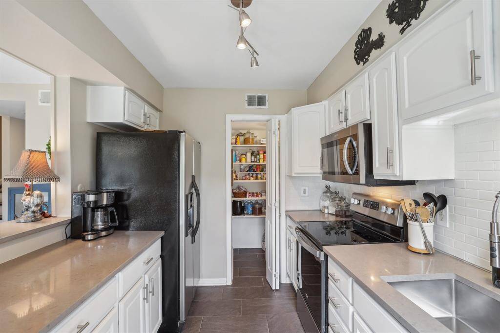 Kitchen featuring quartz countertops and stainless steel appliances.