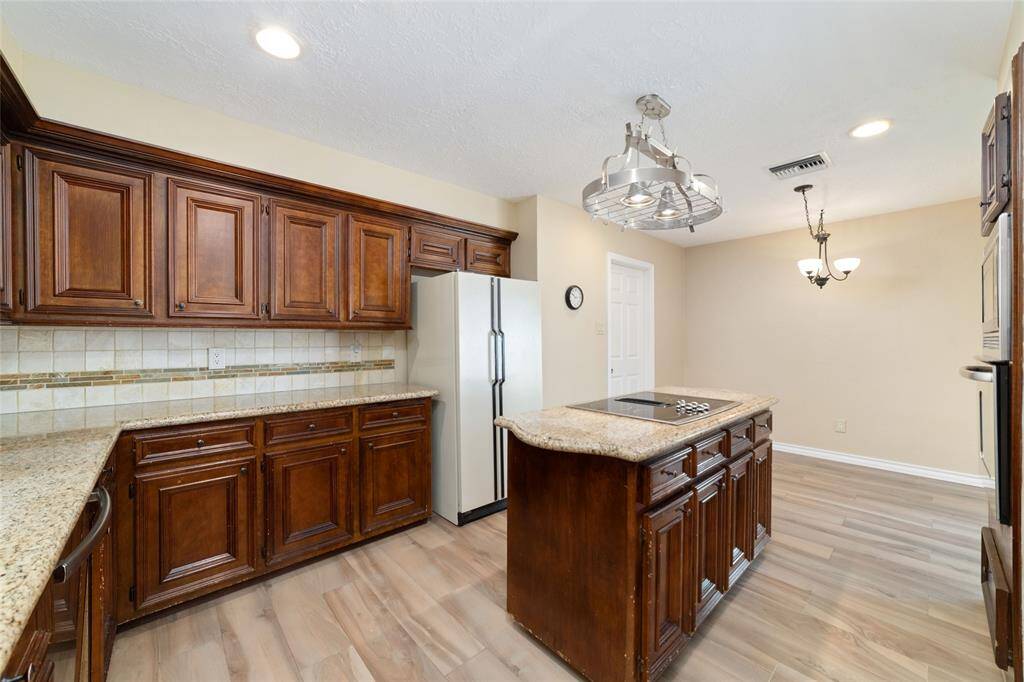 Spacious kitchen with island and pot rack