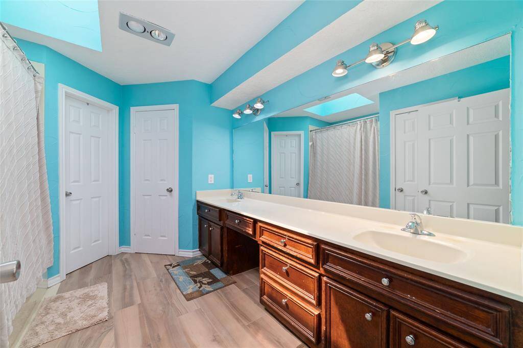 Primary bathroom with dual vanity, soaking tub and shower.