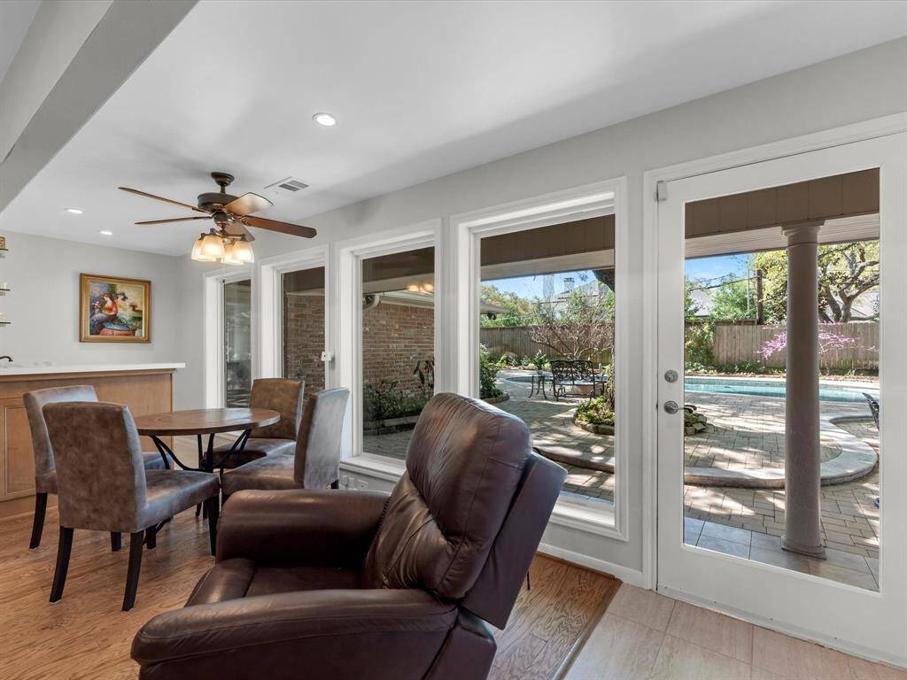 Enjoy a stylish wet bar and cozy sitting area with beautiful pool views, right off the family room.