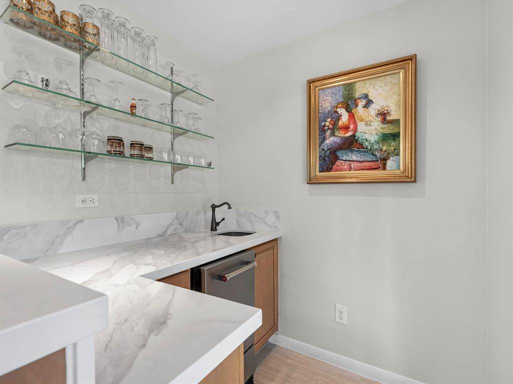 Stylish wet bar with a built-in ice maker, perfect for entertaining.