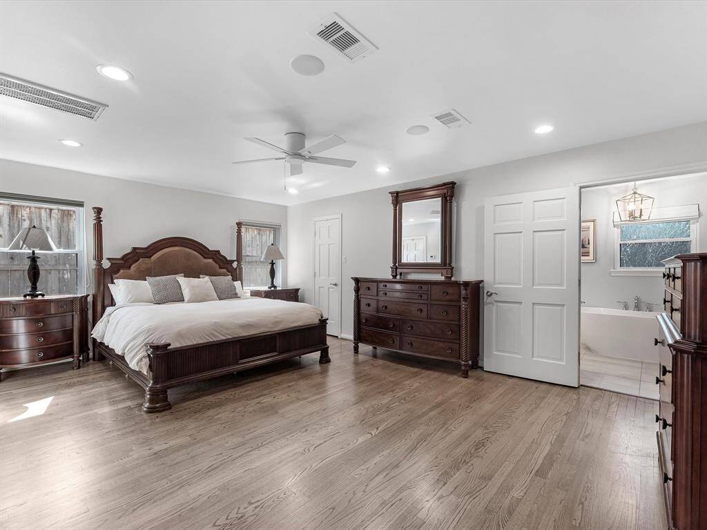 Expansive primary bedroom featuring elegant hardwood floors.
