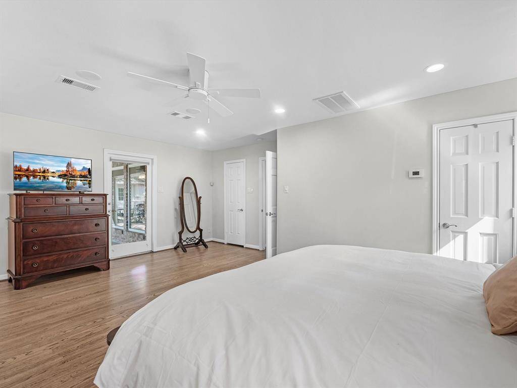 Spacious primary bedroom with direct access to the backyard.