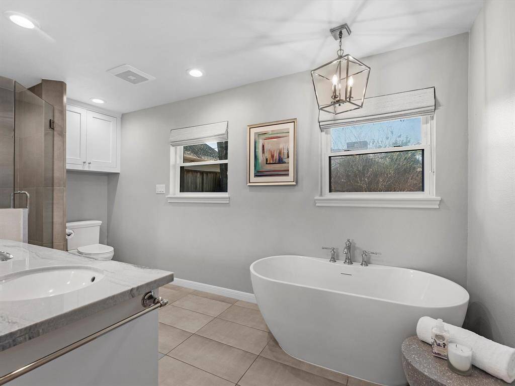 Luxurious and spacious primary bathroom with modern upgrades.
