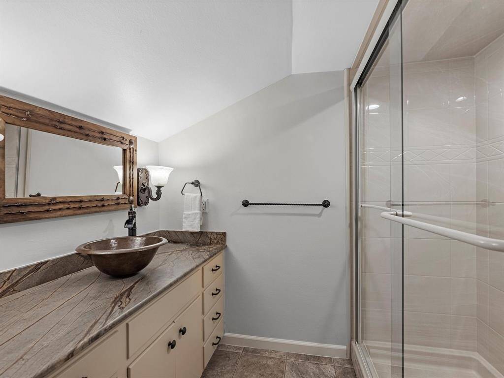 Luxurious upstairs ensuite featuring a sleek walk-in shower.