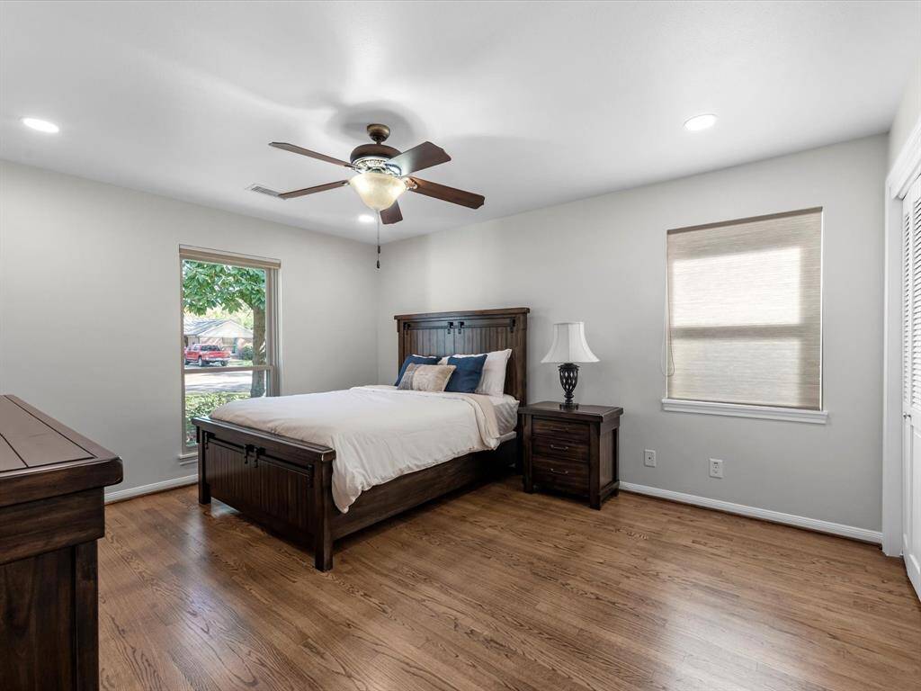 Experience comfort in this spacious bedroom with charming front yard views.