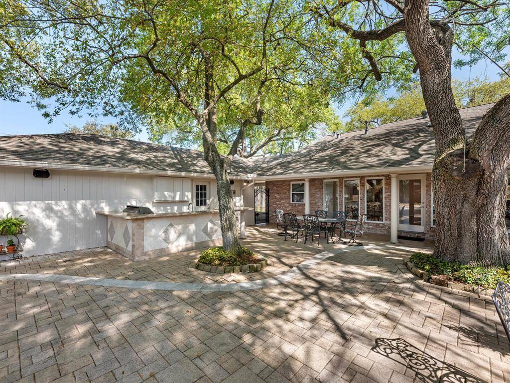 Enjoy the outdoor kitchen complete with a built-in TV area, perfect for entertaining.
