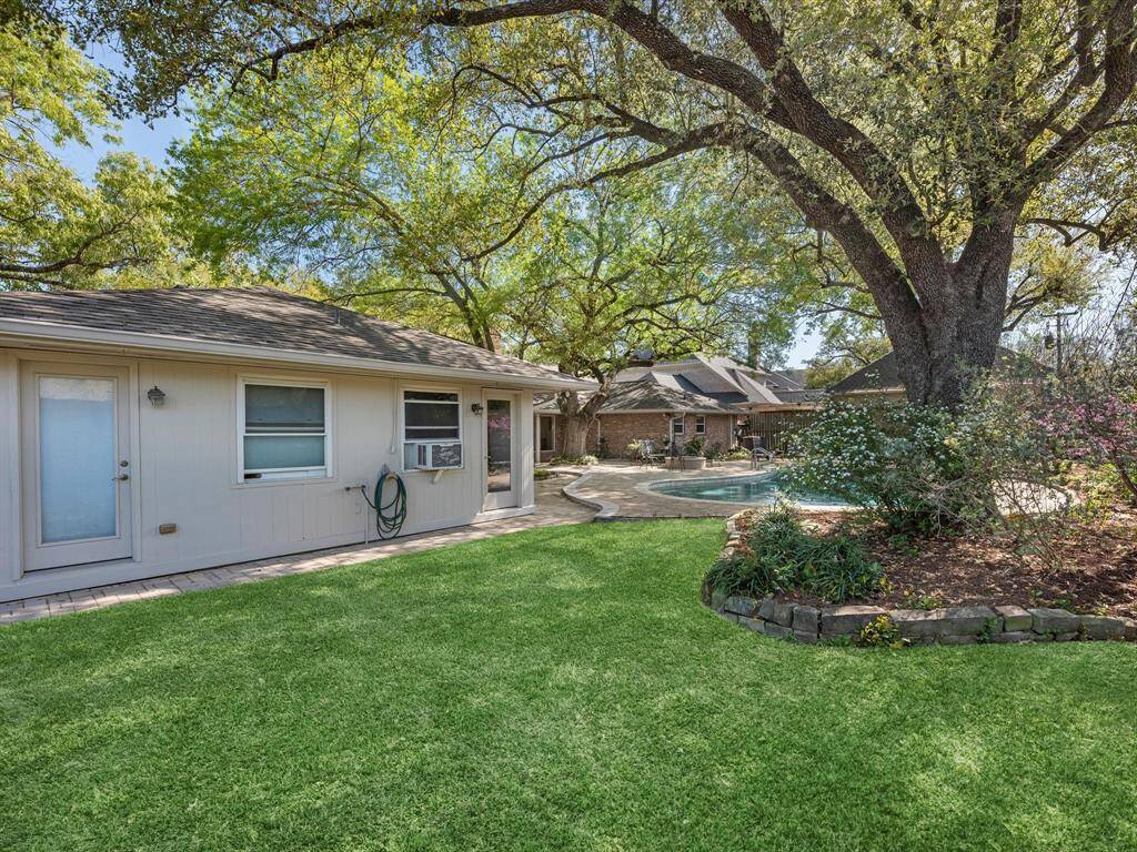 Enjoy extra green space and a convenient private bathroom for guests by the pool.