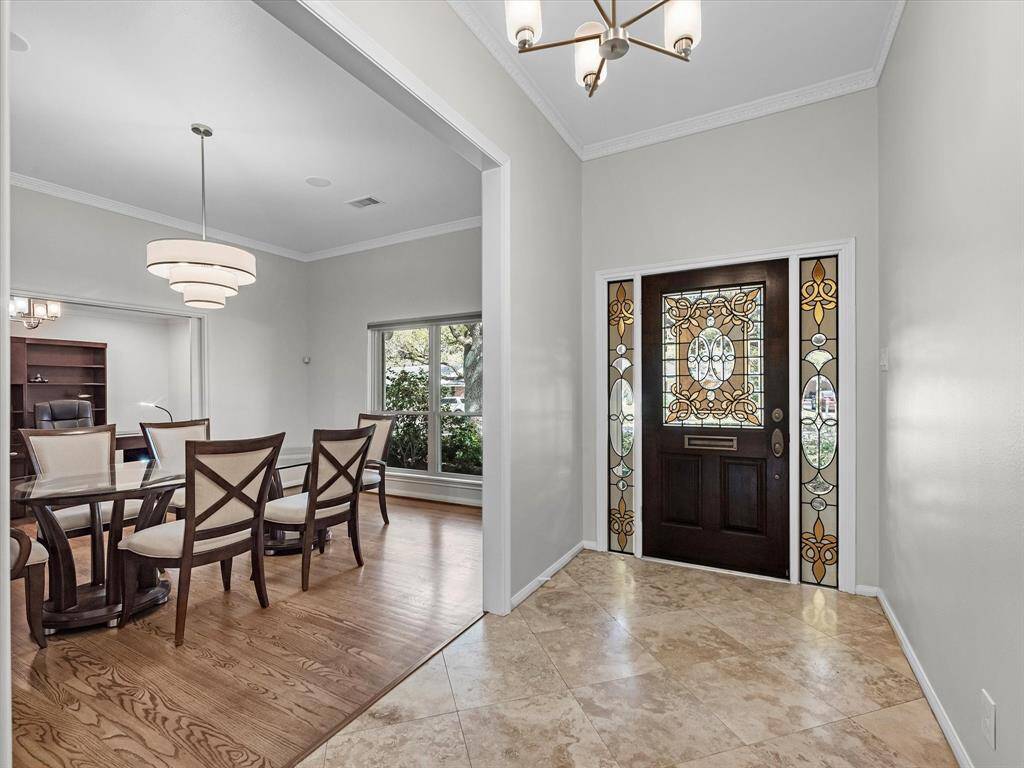 Step into a spacious foyer with an elegant formal dining area to your right.