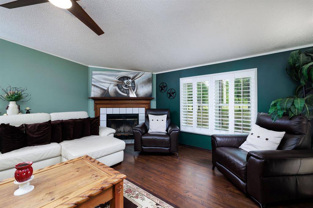 Fireplace next to the plantation shutter in living and dining rms