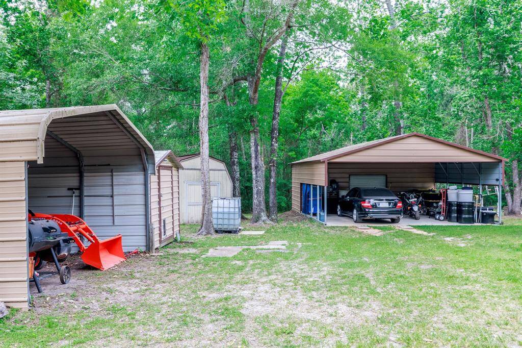 3 sided car port, 2 storage buildings plus...