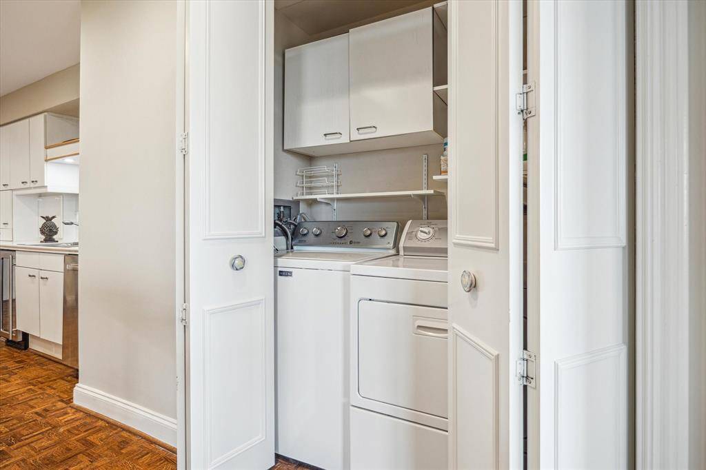 Laundry room off kitchen with excellent storage.