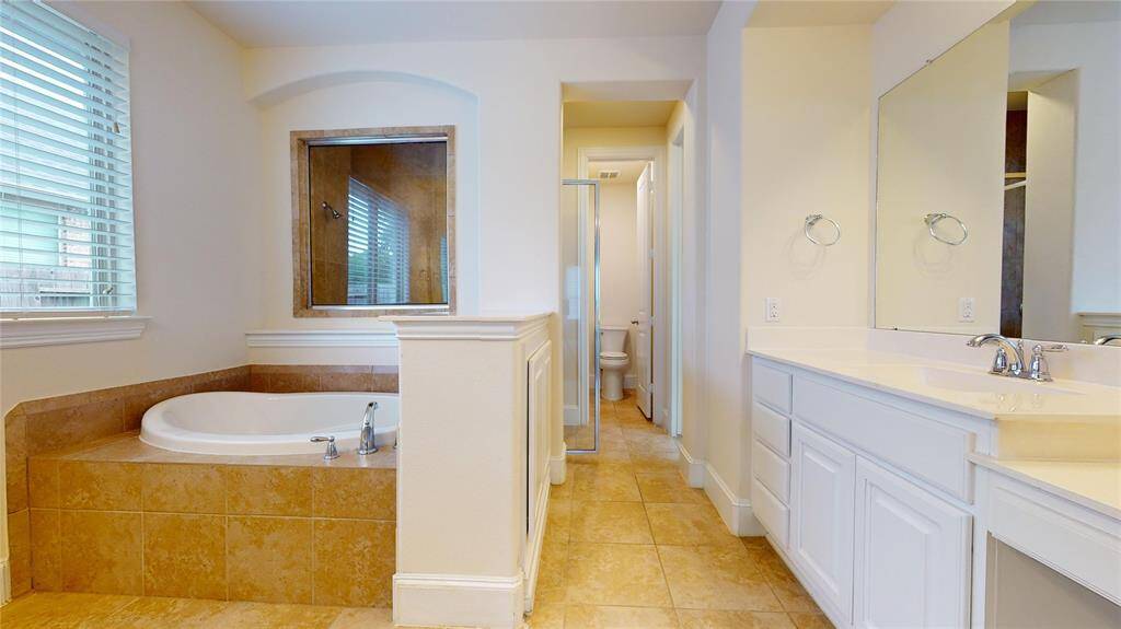 Primary bathroom with dual sinks and vanity counter