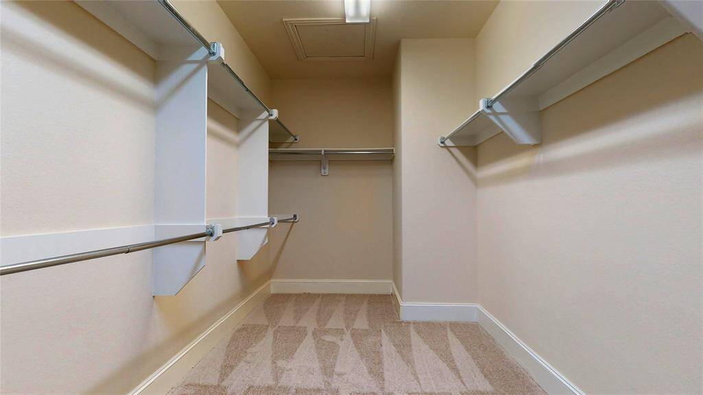 Huge walk in closet in the primary bedroom that connects to the laundry room