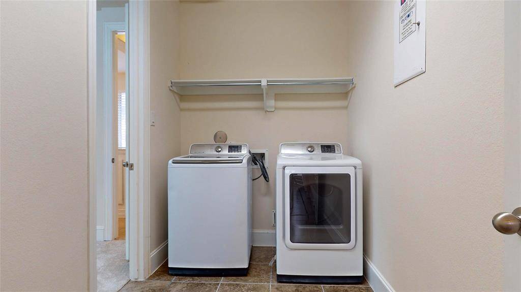 Access the laundry room from the primary bedroom or the hallway near the garage