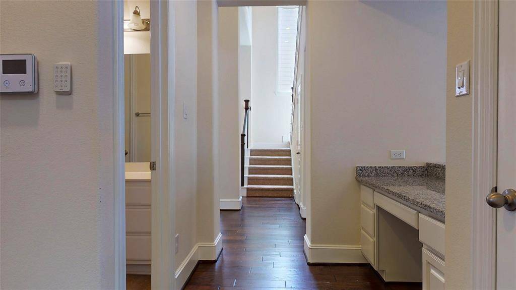 Hallway to the second bedroom on the primay floor where you will find a built in desk