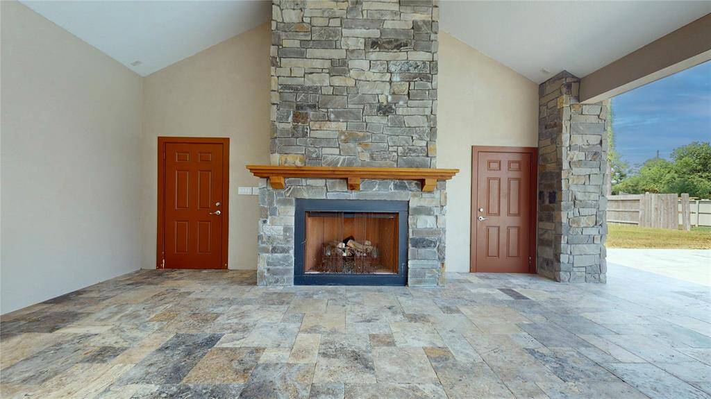 On one side of the fireplace is a storage room and on the other side is a spacious half bathroom
