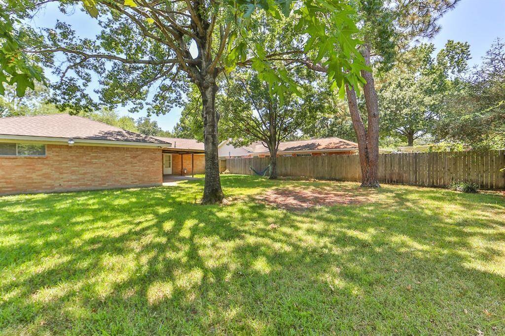 Spacious backyard with  mature  trees