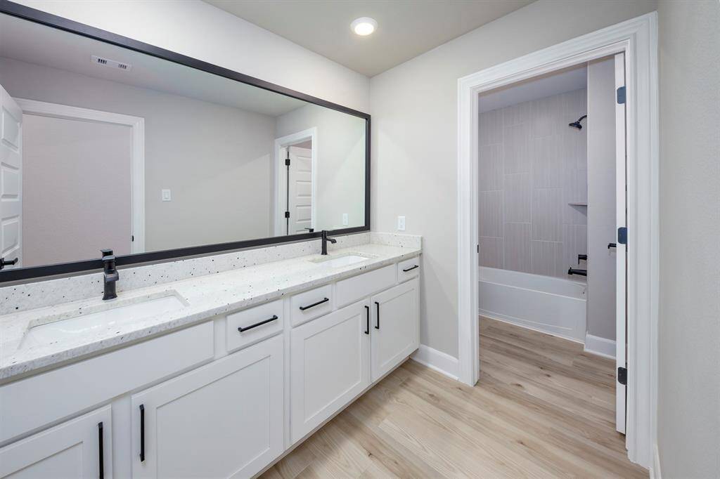 Each bathroom has expansive vanities offering an abundance of storage below.