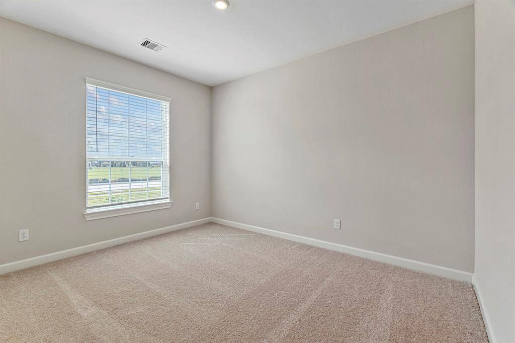 This secondary bedroom is a tranquil escape that offers enough space for whatever you need it to be. Whether you use it as a home office or a comfortable guest room, this space invites relaxation and reflection.