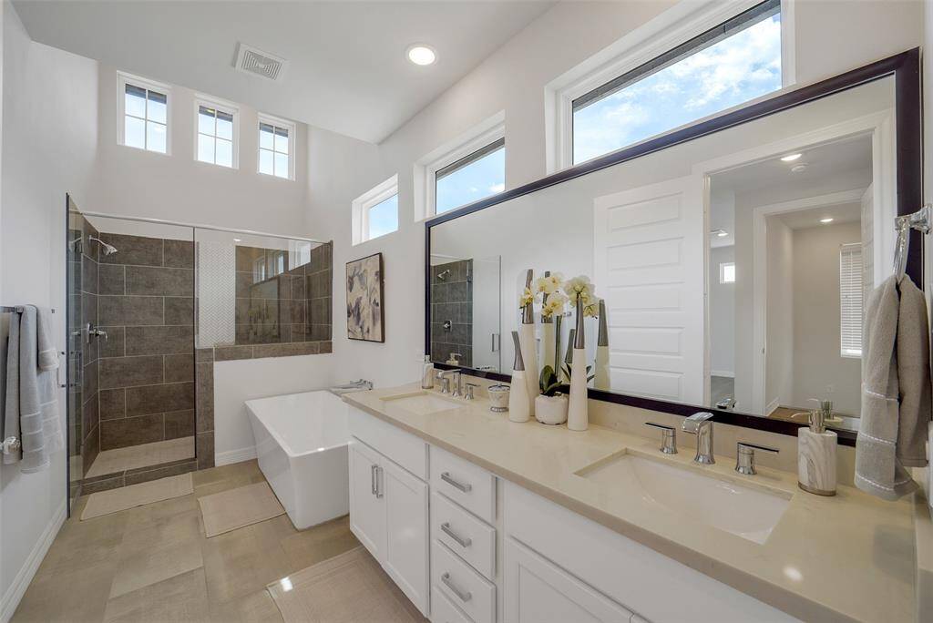 Spacious & modern, the primary bathroom exudes a luxurious feel with a sleek walk-in shower & a separate soaking tub, offering the perfect blend of relaxation & style.