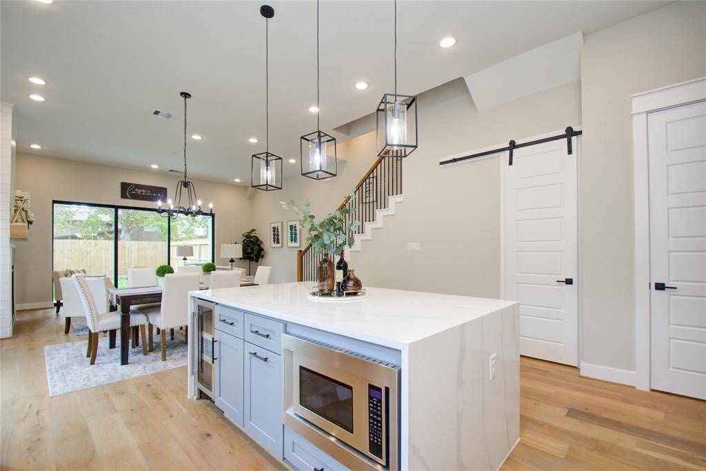 Waterfall, marble island with built in wine cooler and microwave