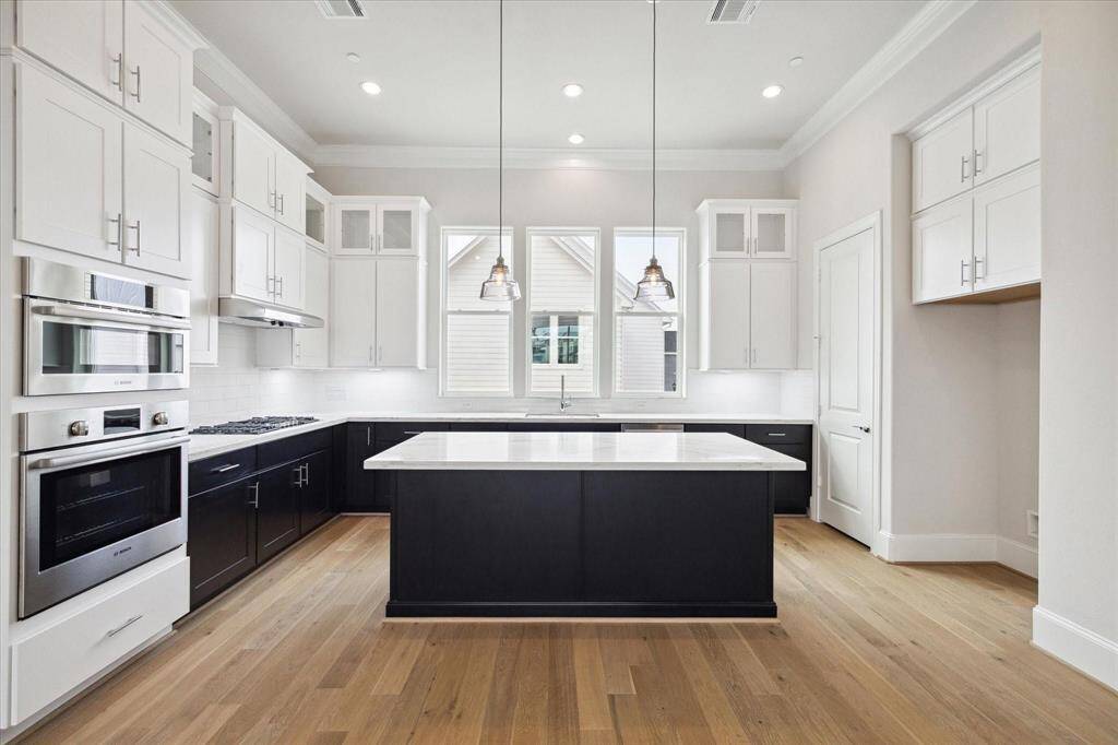 Spacious kitchen with LARGE island. This photo is from a previous build of similar design.