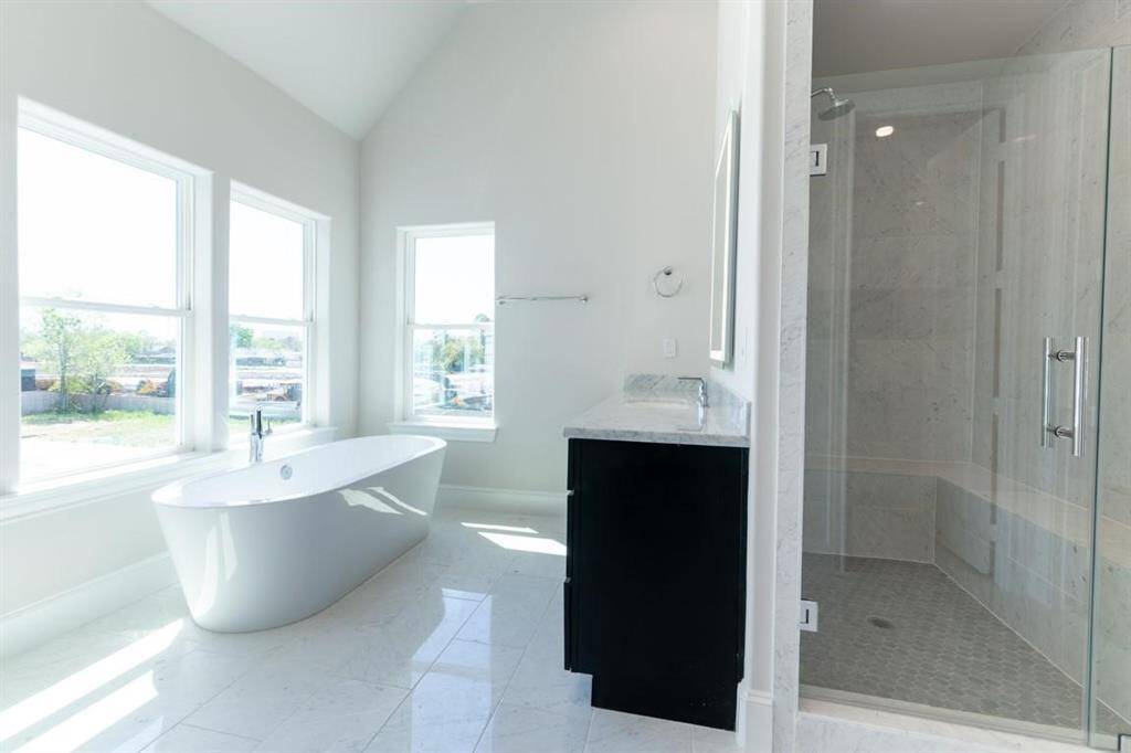 Primary bath boasts a free-standing tub and separate shower.