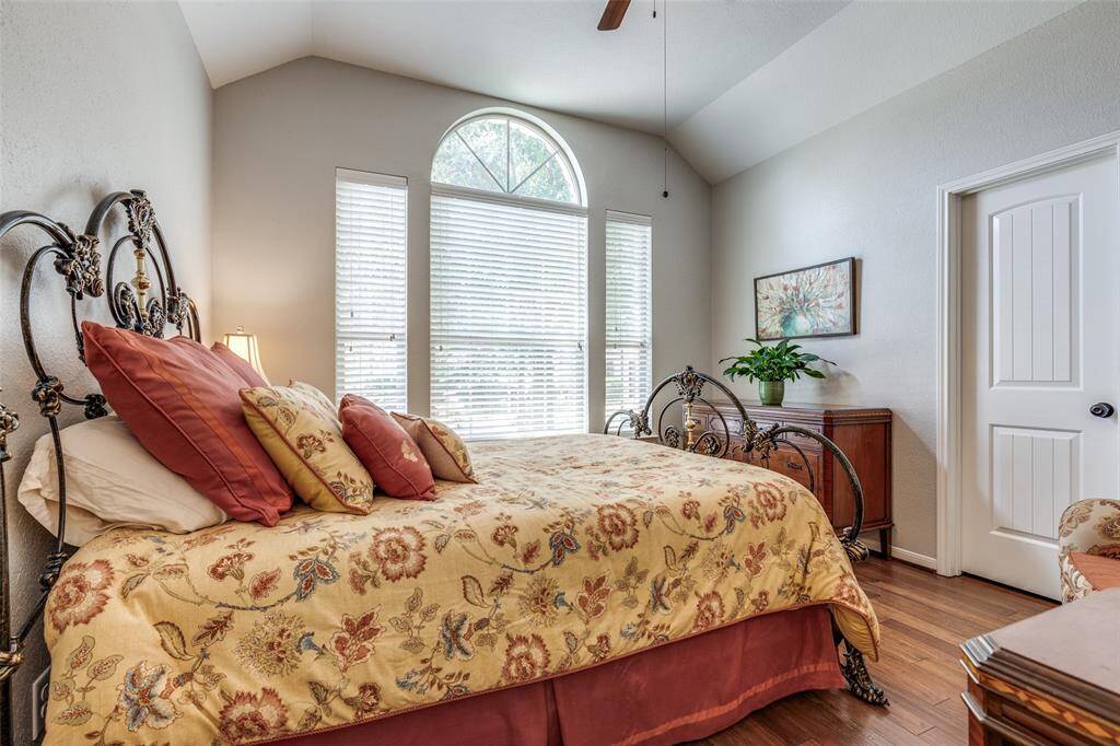 Bedroom at the front of the house with large windows. Large walk in closet behind door.
