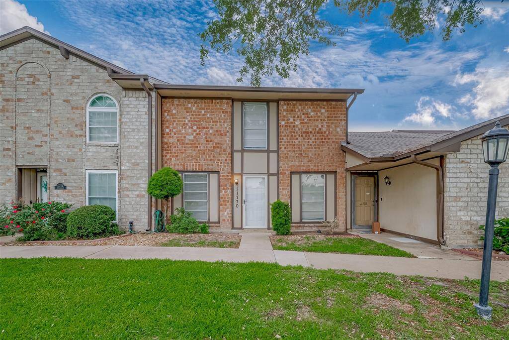 The home’s exterior showcases warm brickwork and a welcoming front door—charming curb appeal that complements the comfortable interior.