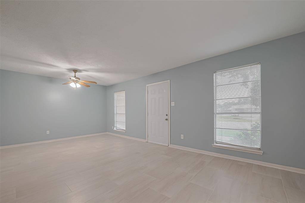 The entryway sets the tone with a glimpse of the main living areas beyond, opening first into the adjacent sitting area for a warm welcome.