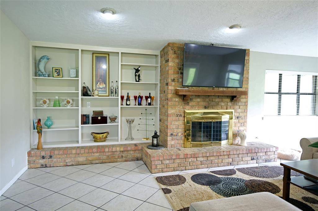 Living Room with built in Shelves and Fireplace! Lots of Natural Light!