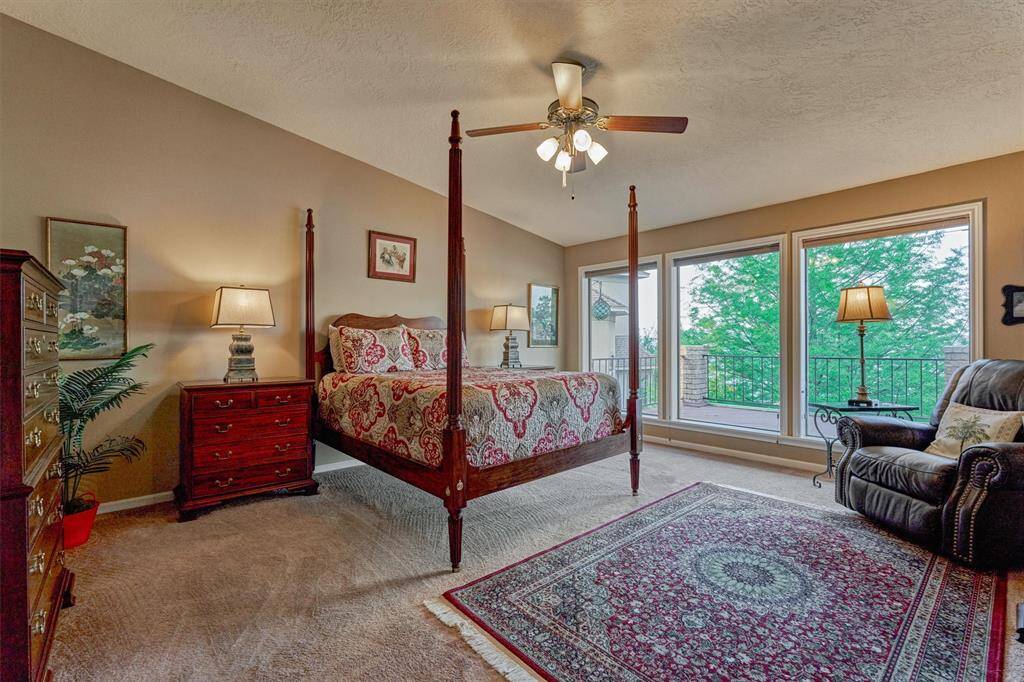 Three expansive windows in the primary bedroom offer natural light and serene views, with shades that can be raised or lowered for light or privacy.