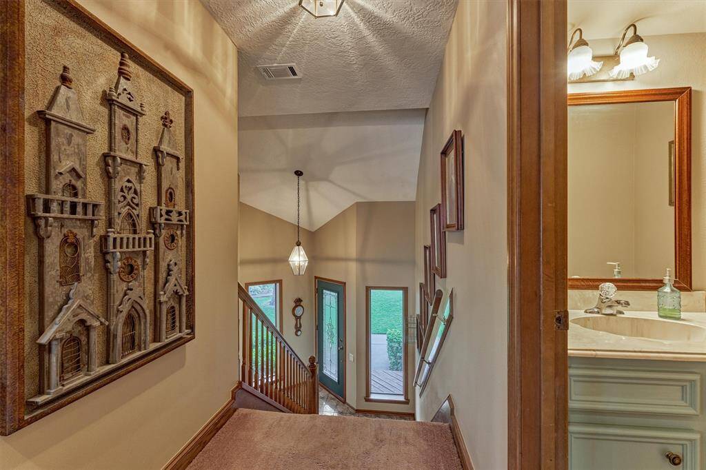 Looking down from the top level, you’ll see the front entry and a well-placed half bath on the right, perfect for guests.