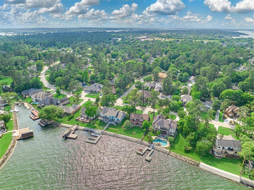 The rear view of the property highlights the expansive backyard and durable concrete bulkhead.