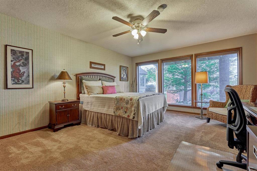 A second guest bedroom also features large windows overlooking the lake.