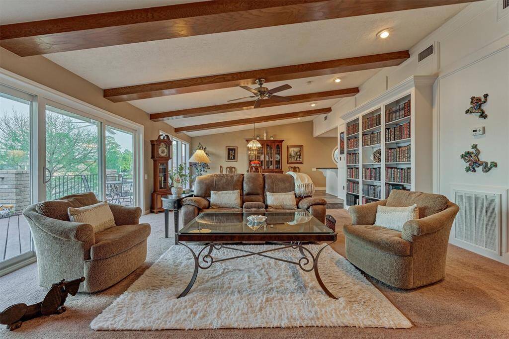 Built-in shelving offers both functional storage and a stylish space to display décor. Just beyond, the dining room and kitchen create a seamless flow for everyday living and entertaining.