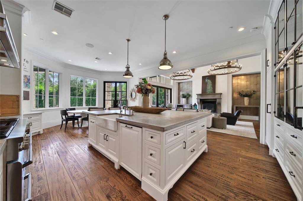 Gourmet kitchen featuring top-of-the-line finishes, custom cabinetry, and premium appliances. Kitchen features two built in refrigerators, island storage, breakfast nook, and gas range.