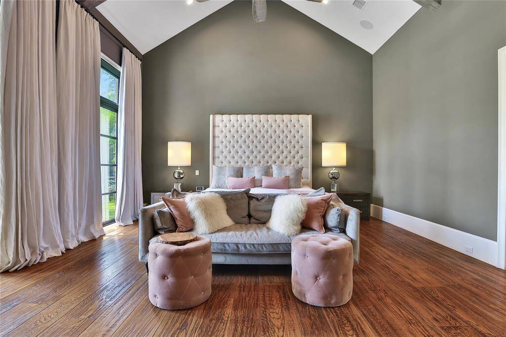 Primary suite features vaulted ceilings, fireplace, and backyard views.