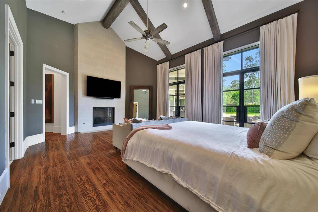 Primary suite features vaulted ceilings, fireplace, and backyard views.