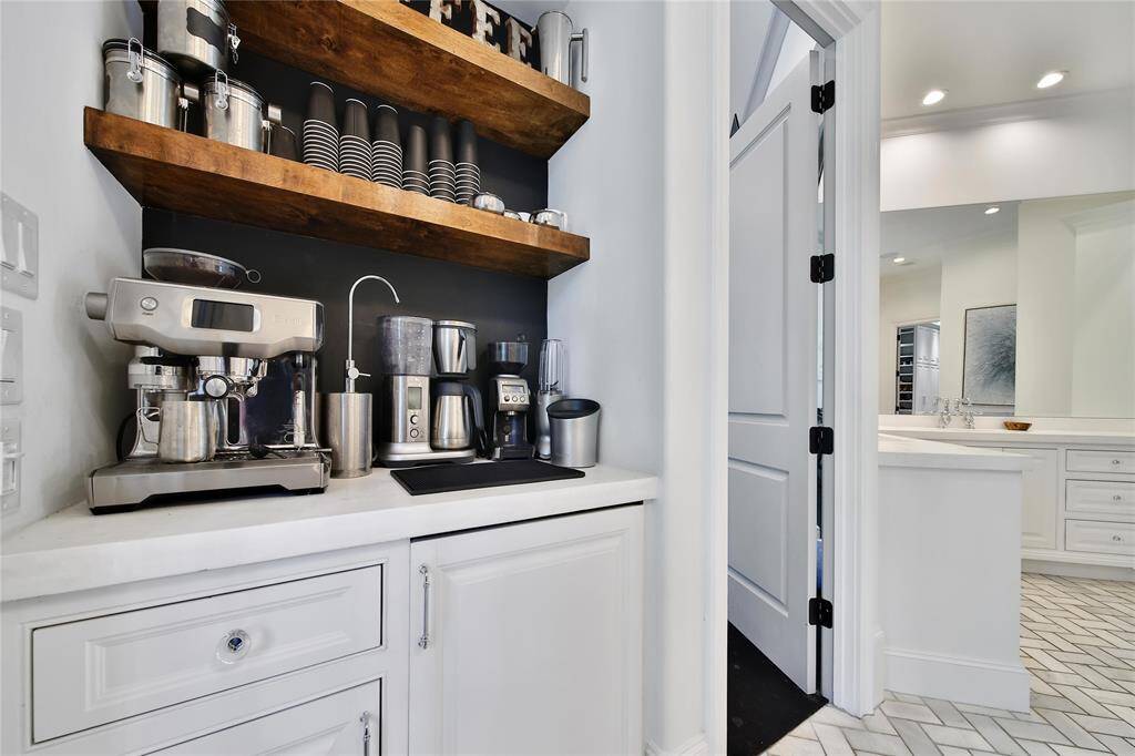 Gorgeous primary bathroom with double sinks, dual shower heads, bathtub, coffee bar, and two closets.
