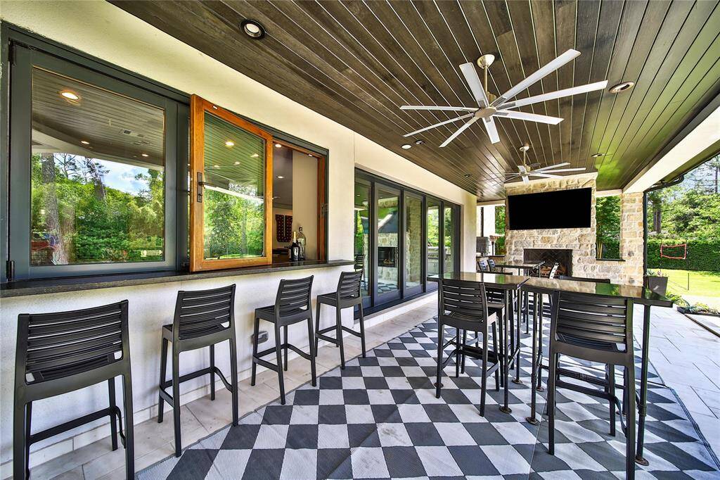 Spacious outdoor patio seamlessly connected to a full bar, perfect for relaxing and entertaining guests.