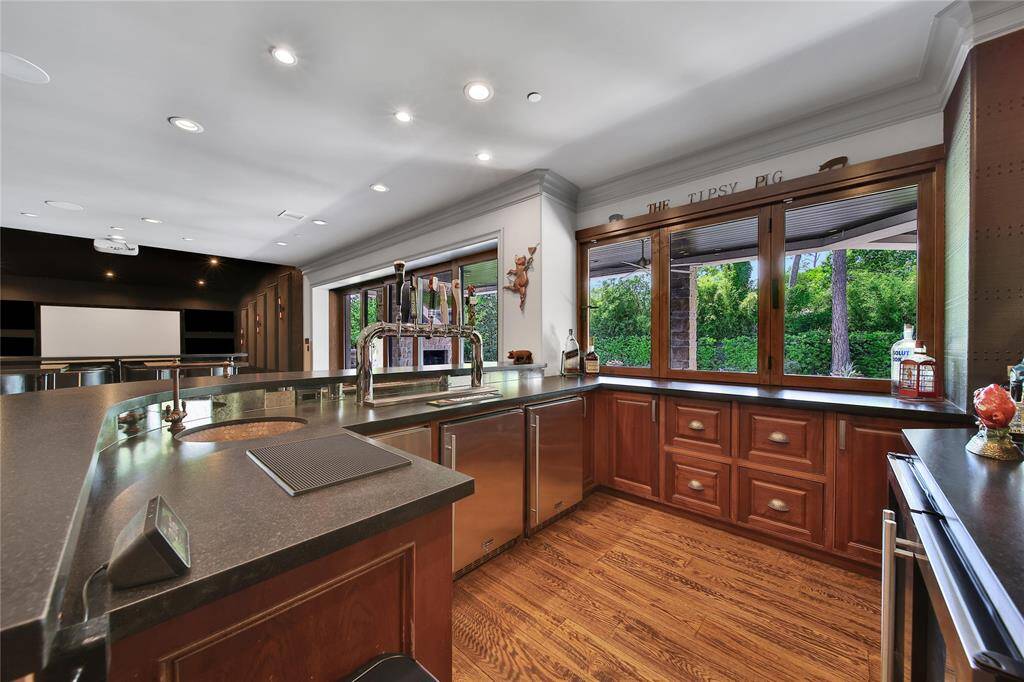 Full bar equipped with two mini refrigerators, dishwasher, prep sink, and more!