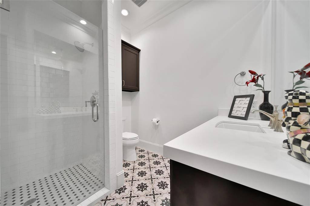 Secondary bathroom with glass shower.