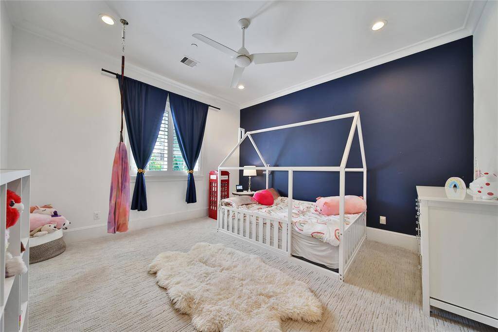 Upstairs secondary bedroom with ensuite bathroom and spacious closet.