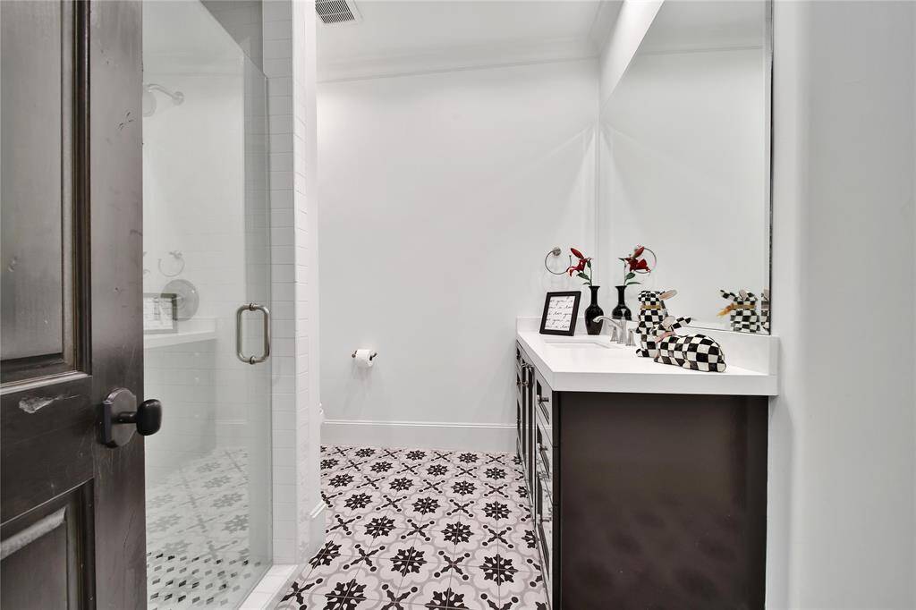 Upstairs primary bedroom featuring vaulted ceilings and ensuite bathroom.