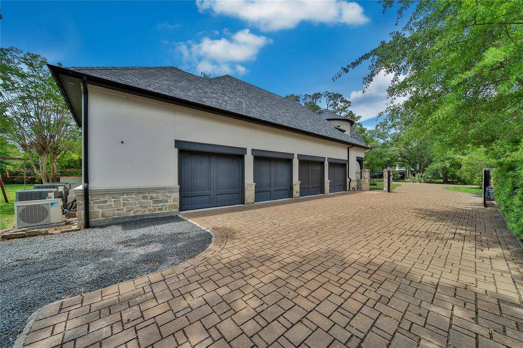Attached 4-car garage with a private driveway gate, offering both ample parking and added privacy.